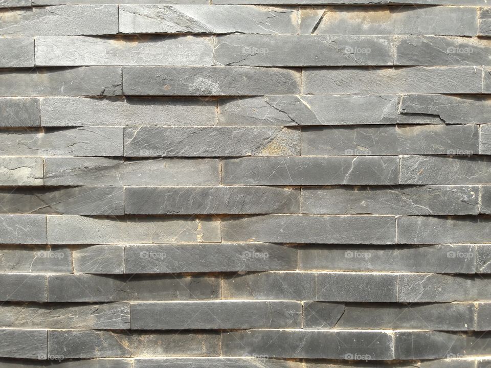 hand cut stone tiles in pattern design on wall work