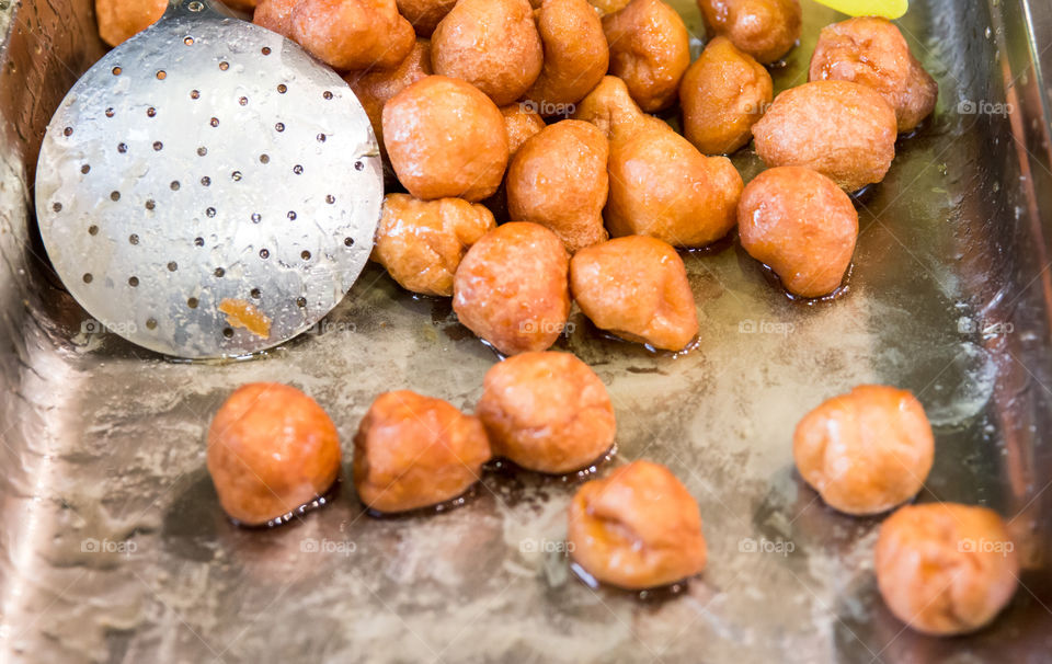 Greek Loukoumades Donuts With Honey, And Metal Skimmer
