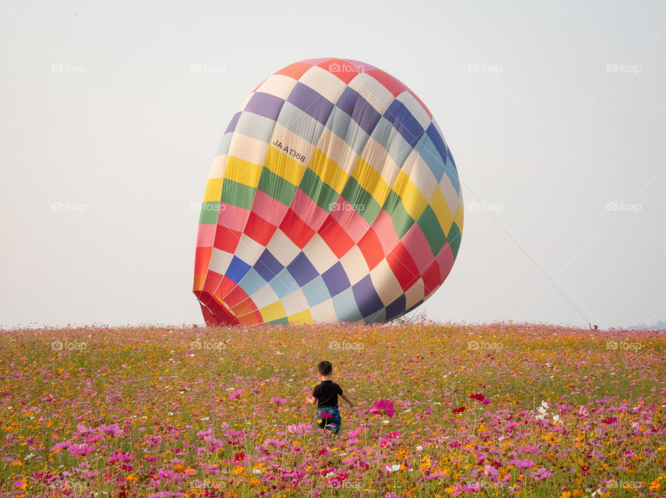 Kids,Flower field and Colorful balloon