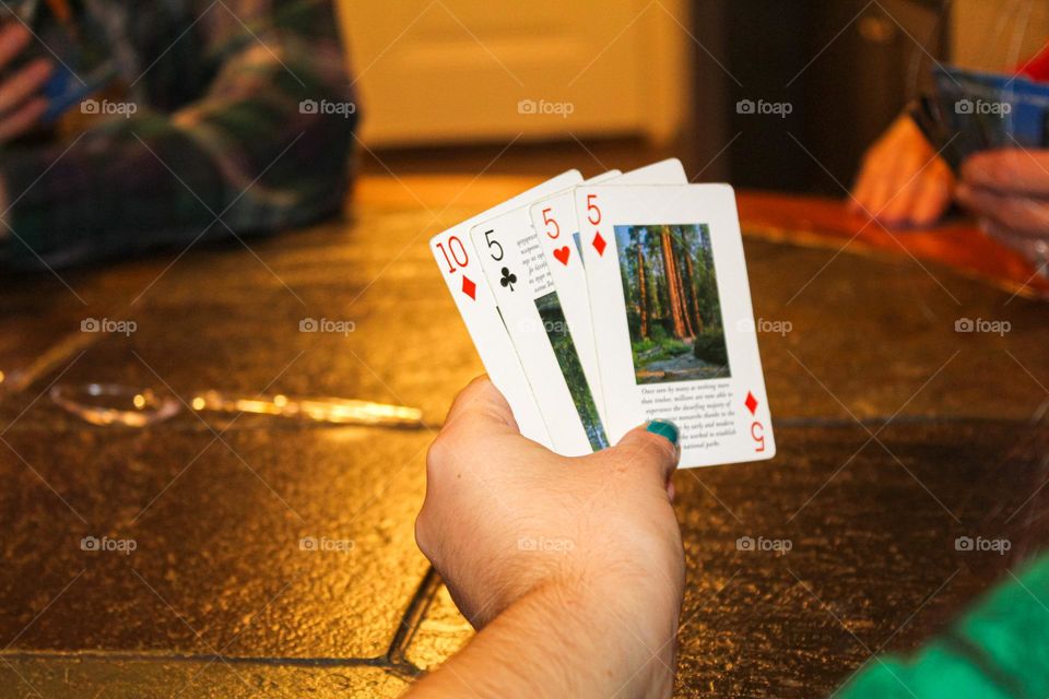 Family members playing a fun card game called spoons at a family holiday gathering. 