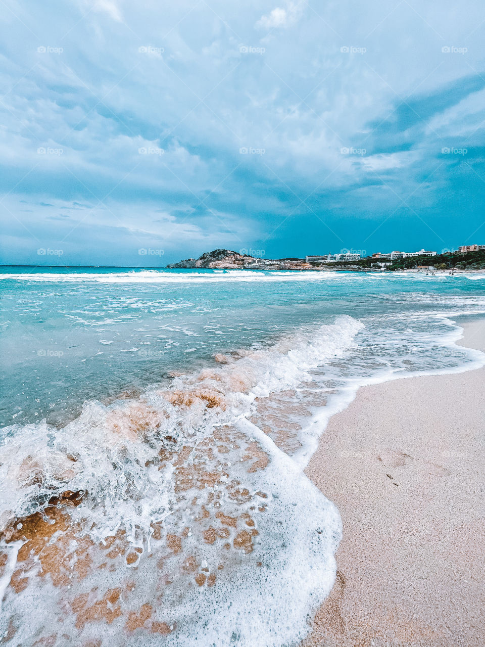 Waves and sandy beach, turquoise waters