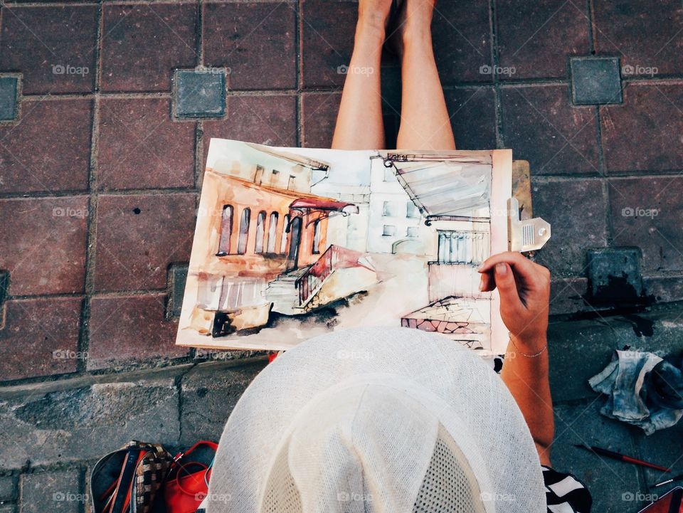 Woman painting on the street 