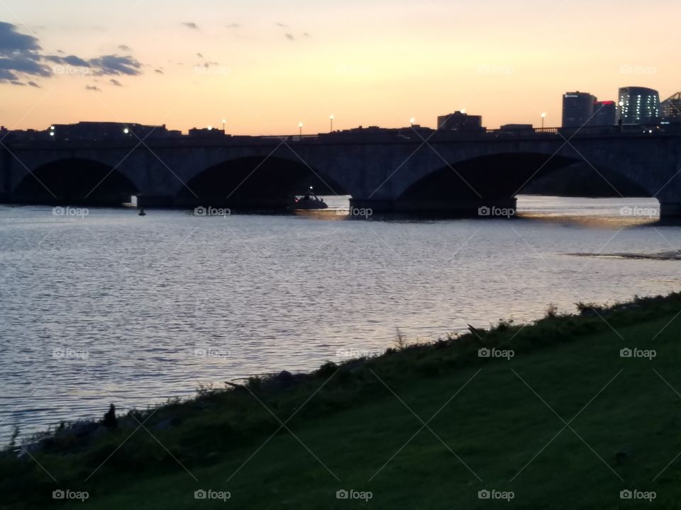 sun setting over a bridge in Washington DC waterfront