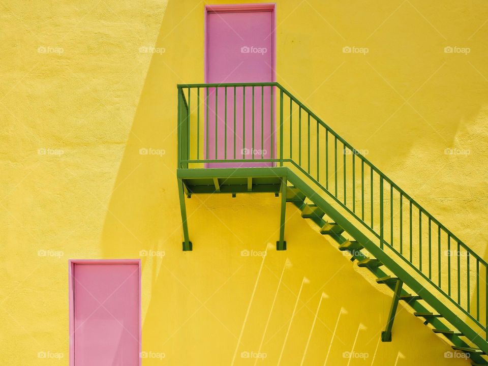 Pink doors green stair and yellow wall
