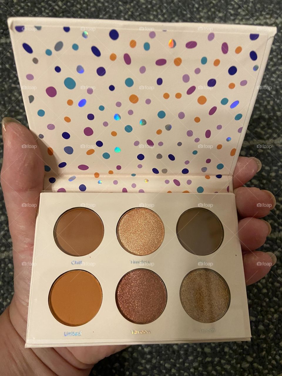 My hand holding Ulta Beauty Fresh Faced 6-piece eye shadow palette, which was part an exclusive collaboration with Essence Magazine called Girls United: Beautiful Possibilities, a special mentoring initiative created by 6 teens per the package info.
