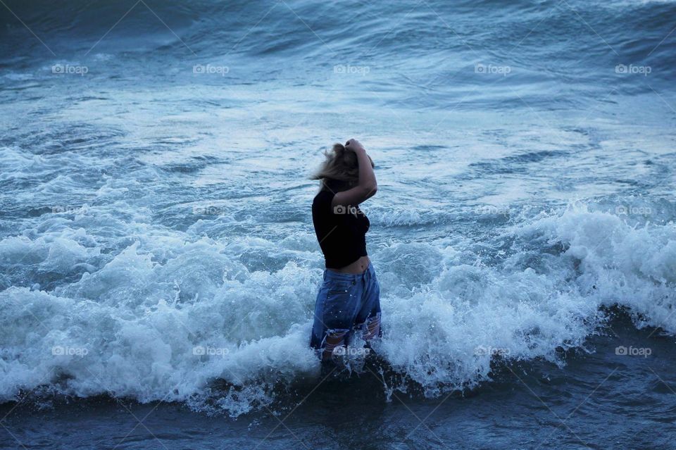 Girl with waves crashing