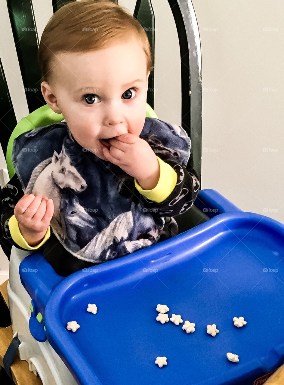 Enjoying his star shaped baby cereal snack 