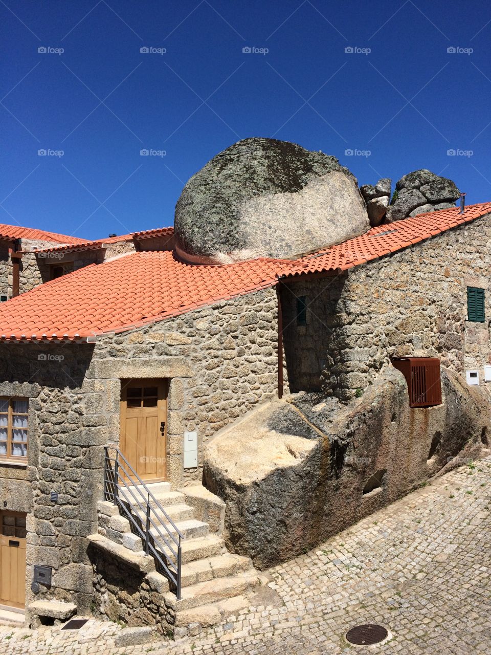 house with a stone on the roof