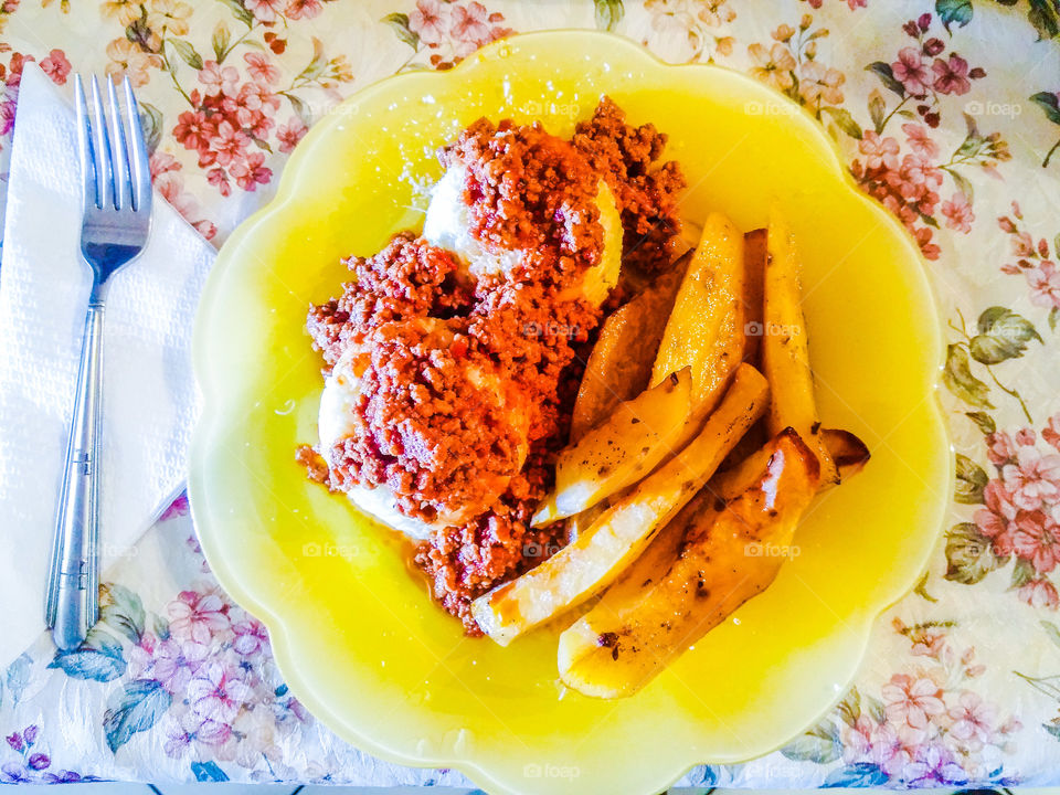 plate with rice, 
minced meat, potatoes and parmesan cheese