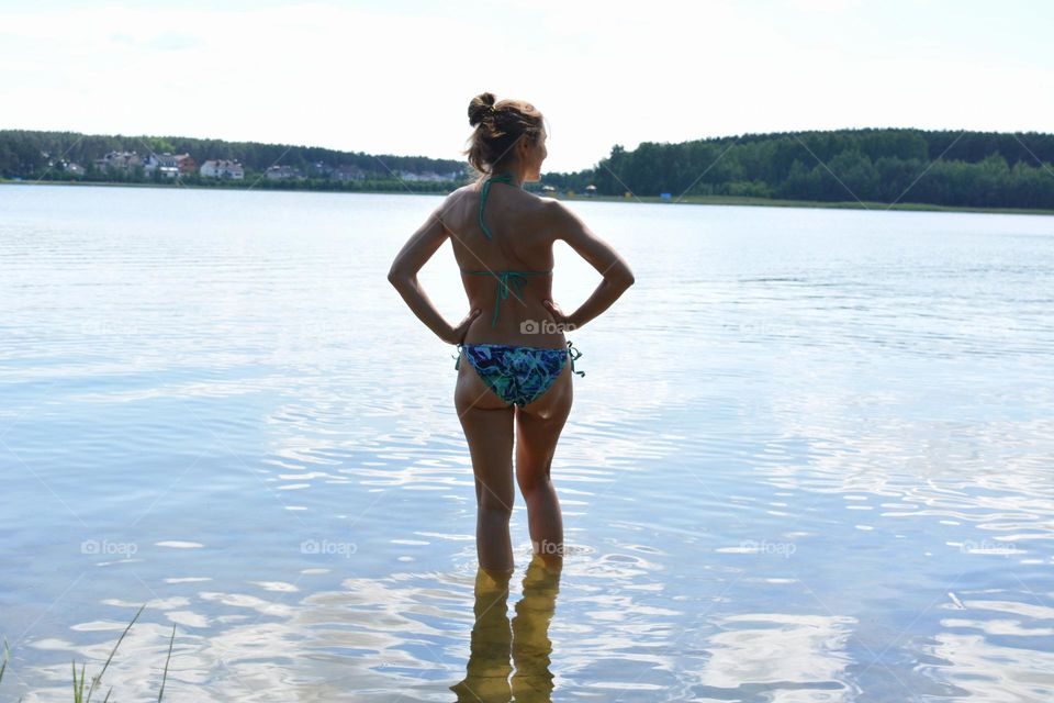 woman on a lake shore happiness