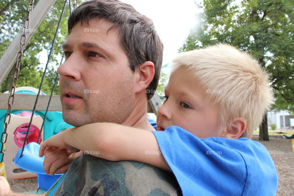 Father giving piggyback ride to his son