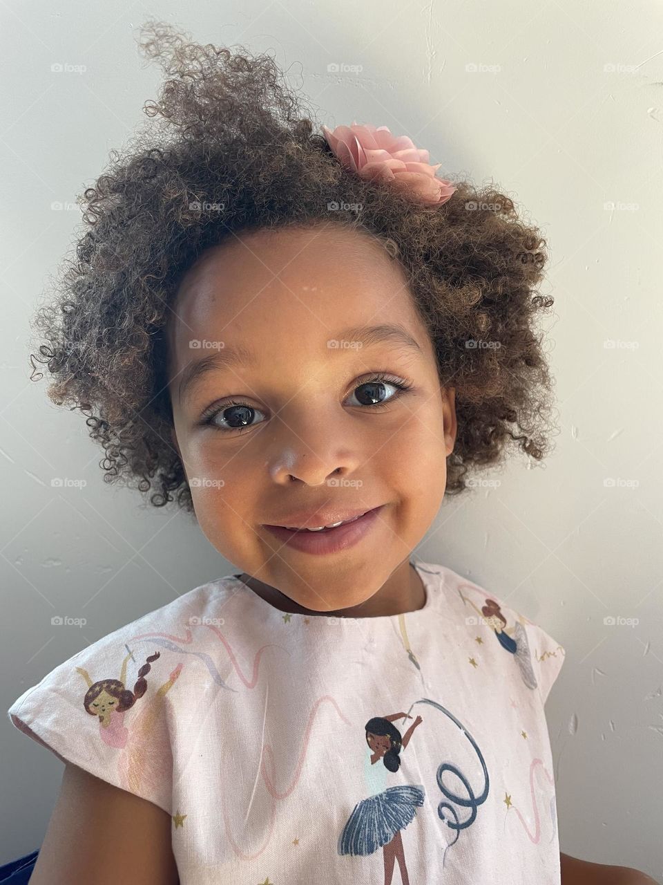 Little cute toddler of mixed race with curly hair