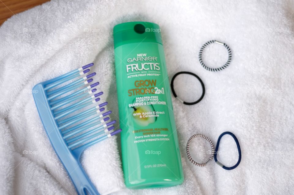 Garnier two in one shampoo and conditioner only white towel with a comb and ponytail bands