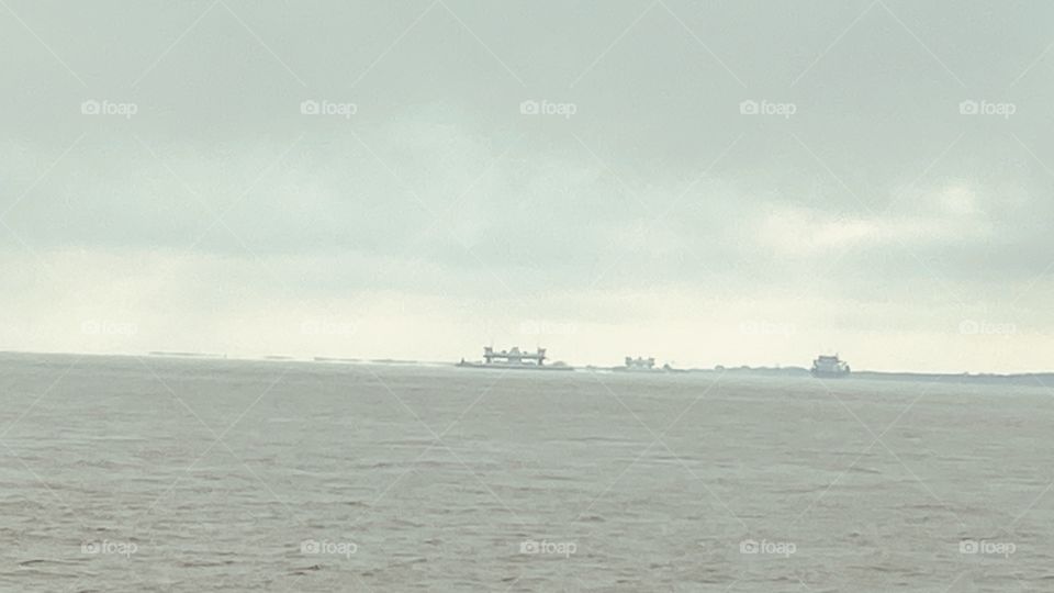 Texas City Entrance to the 5 mile Texas City Fishing Dike. End of Dike looking into Distance to Port Bolivar and Right Galveston Island. Center One of 5 Galveston Ferries.