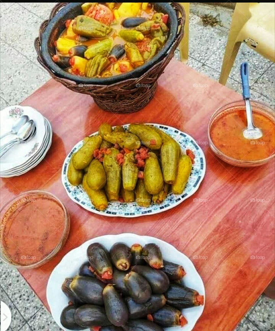 Cooked stuffed zucchini and eggplant with rice and minced meat with tomato sauce