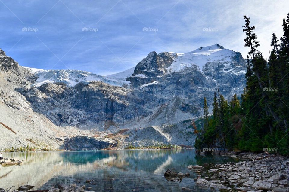 Glaciers, alpine trees and water reflections on Upper Joffre Lake in Pemberton, British Columbia, Canada.