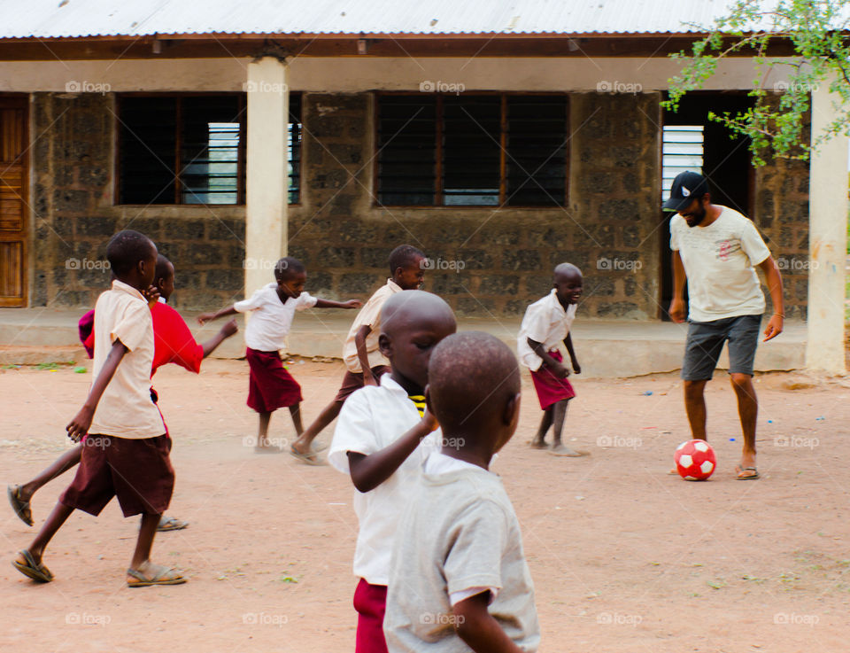 We went to visit a Masai tribe, when suddenly the kids went out of their classroom to play soccer, so I took my time to have fun with them. I laugh a lot playing with children.