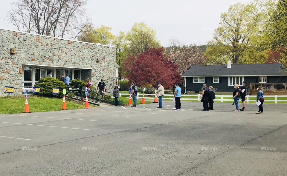 Line of people outdoors waiting for COVID-19 vaccine
