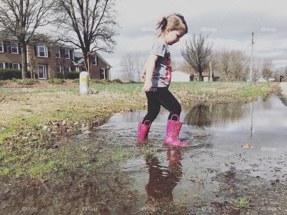 Spring weather means spring fun! For this tiny kid that means mud puddles 