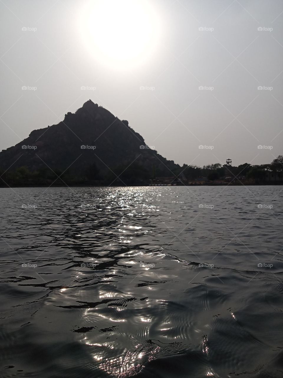 the sun is setting down behind the mountain 🗻