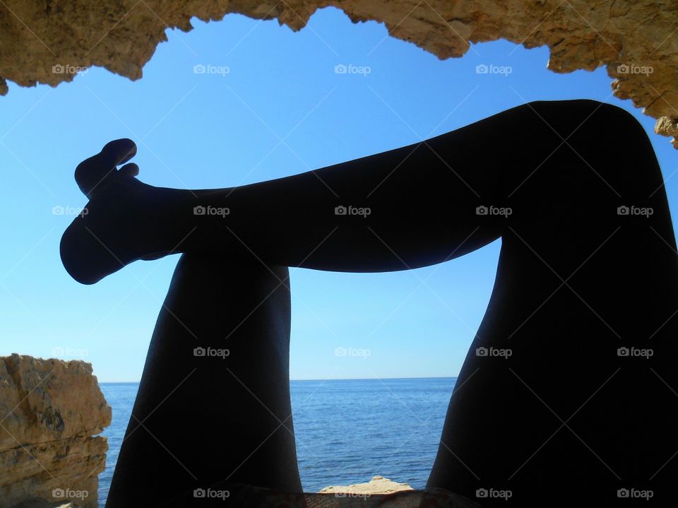 female legs resting on a sea shore summer vacation