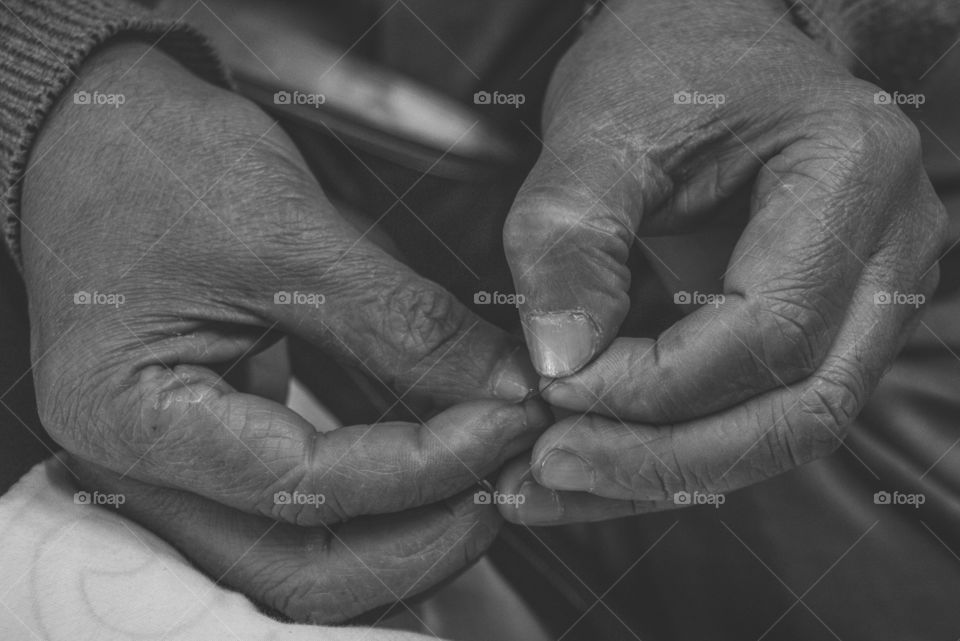 Close-up of man's hand sewing embroidery