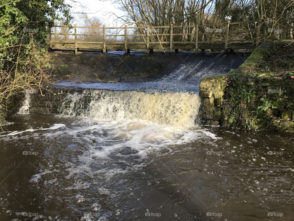 Powerful waterfall flowing through Uffculme, Devon, UK