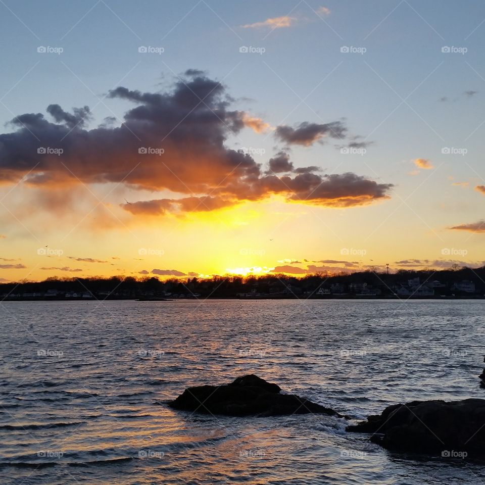 Sunset on the ocean. Sun setting over the ocean