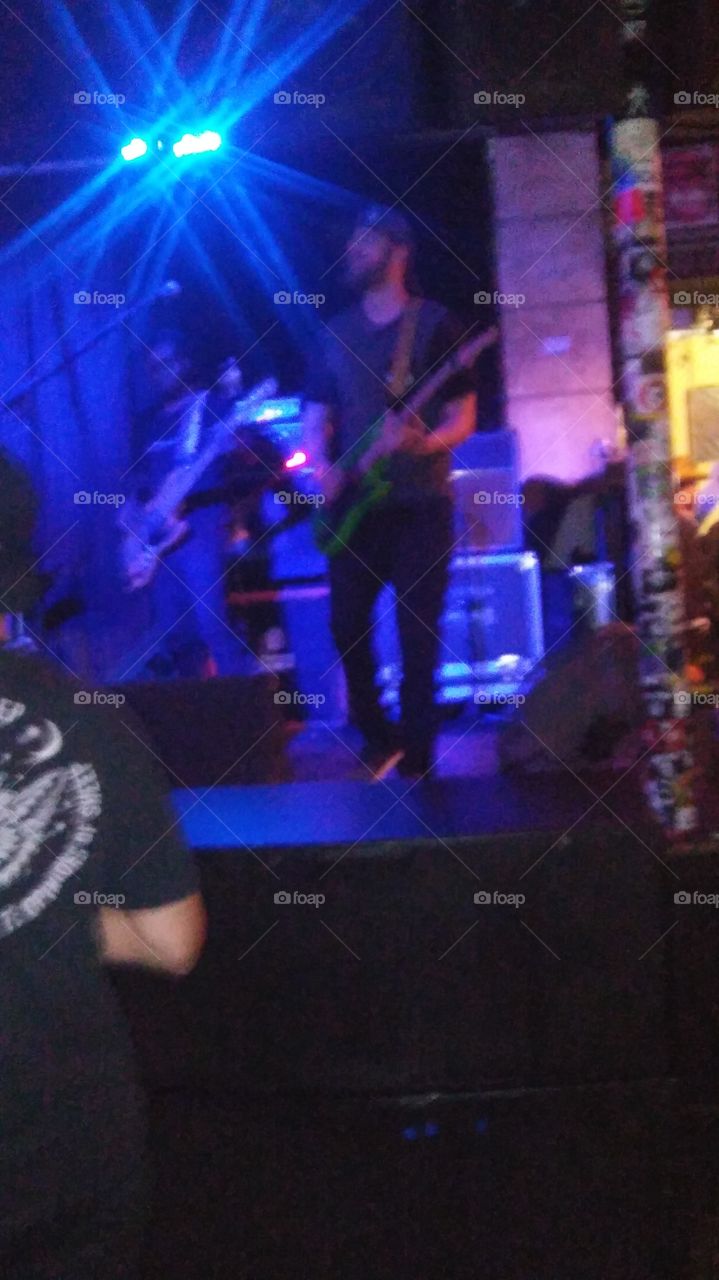 Tyson playing guitar at the Bangarang show