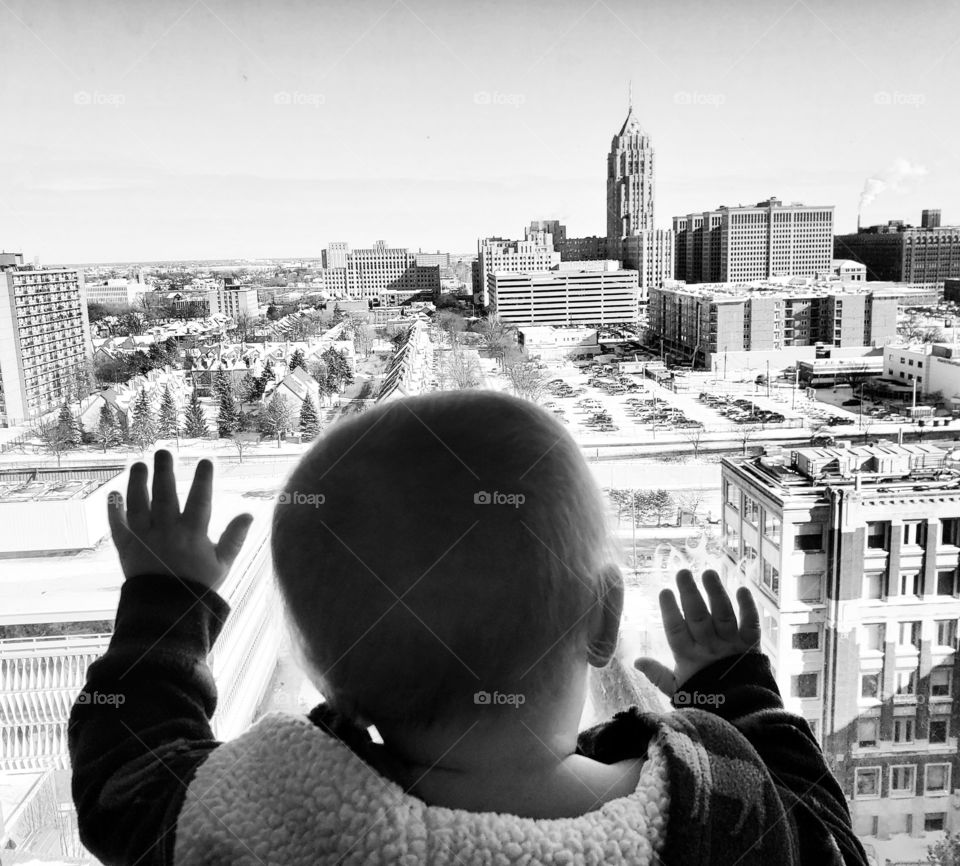 A baby overlooking the city of Detroit.