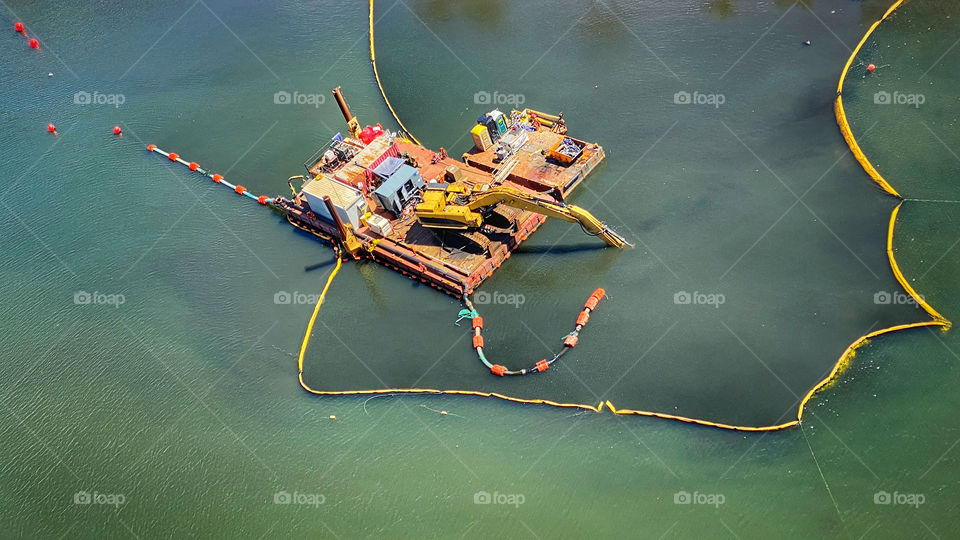 Dredging platform on a polluted canal