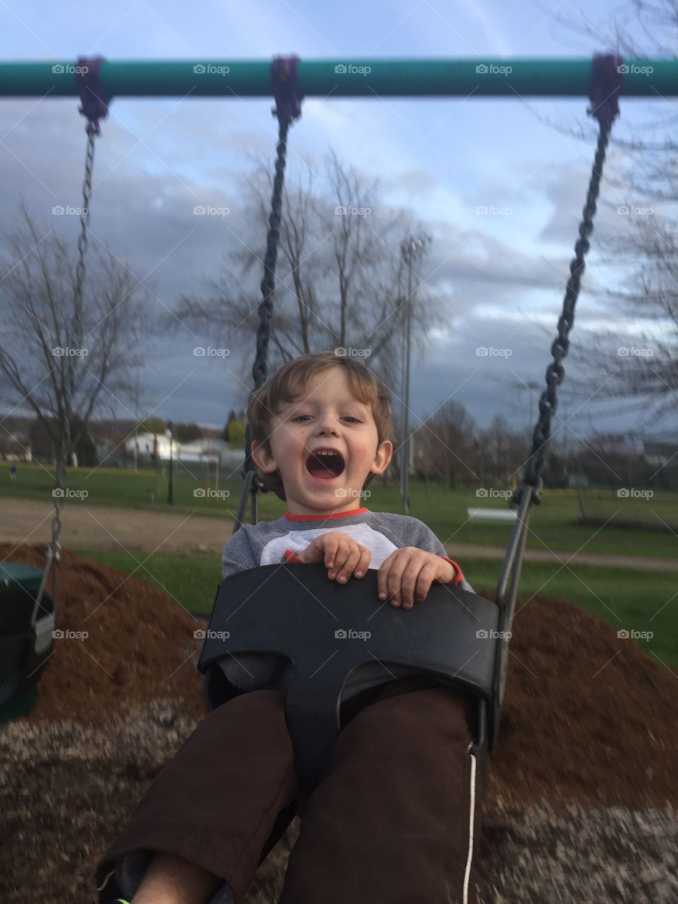 Boy playing on swing