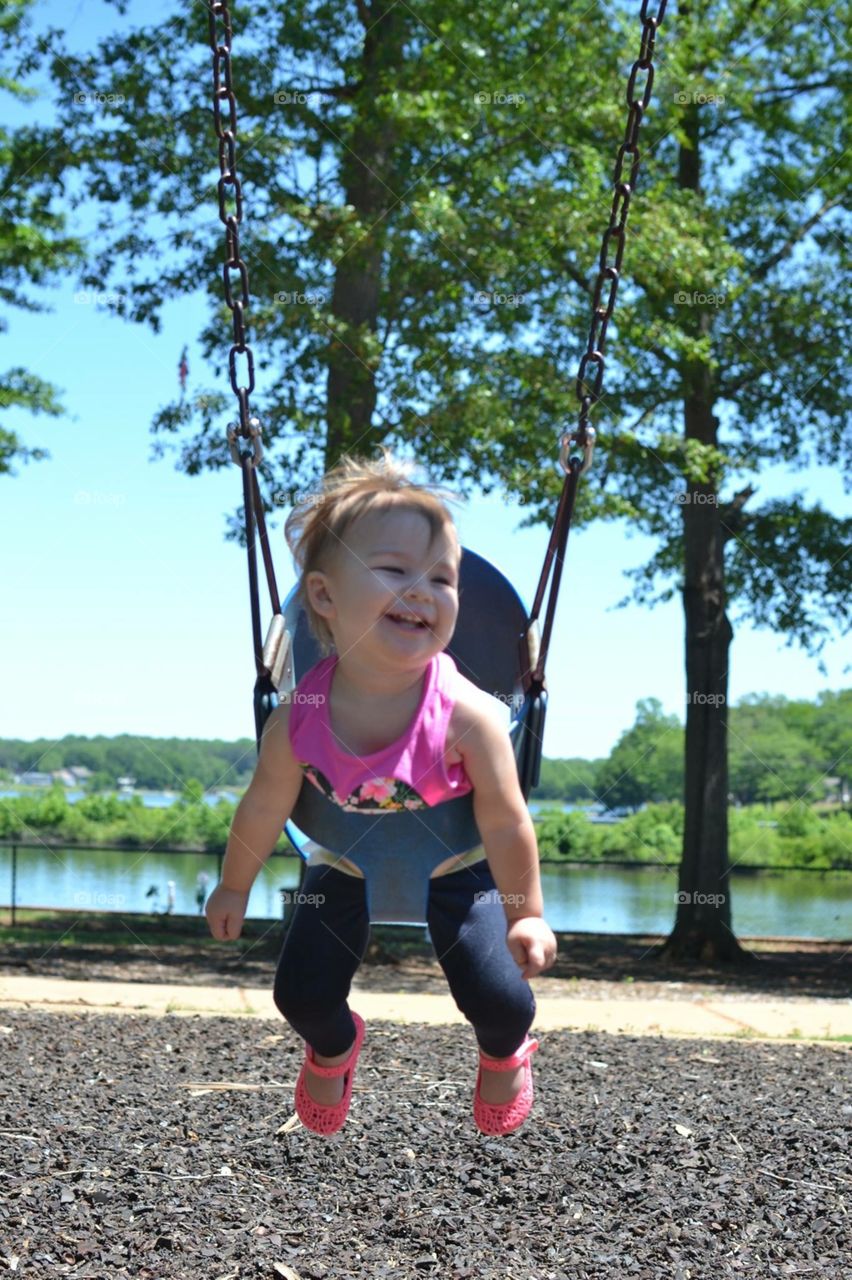 Little girl swinging