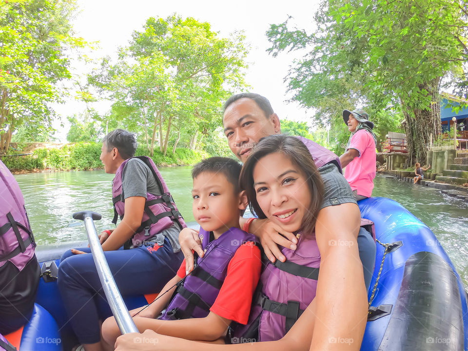 Tourists on the inflatable boat floating on the water in the river The flow of Kaeng Krachan Dam at Phetchaburi in Thailand. June 10, 2019