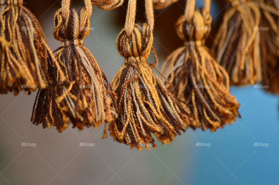 Orange tassels hanging on curtain