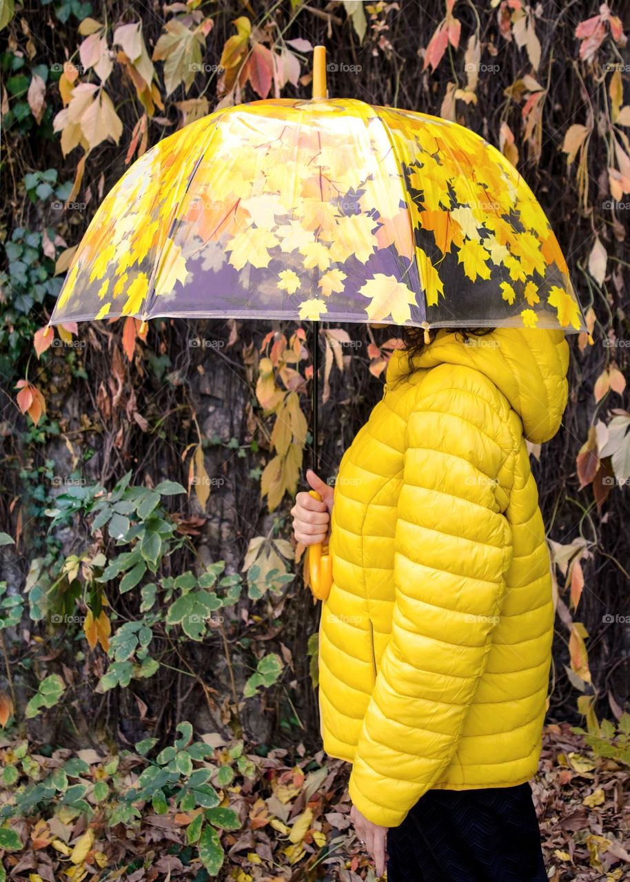 Woman with Umbrella on Autumn Background