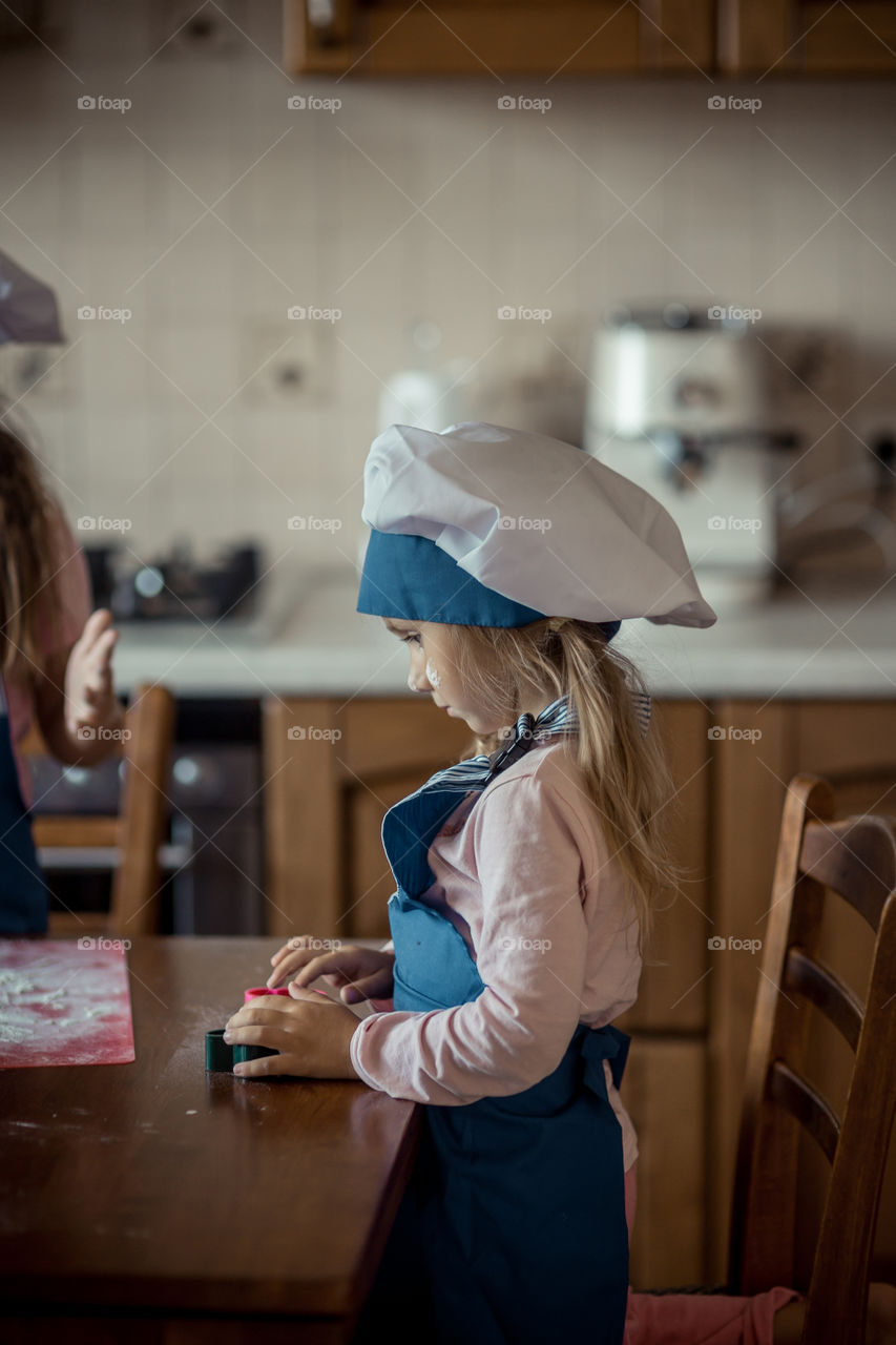 Little sisters cooking the biscuits 