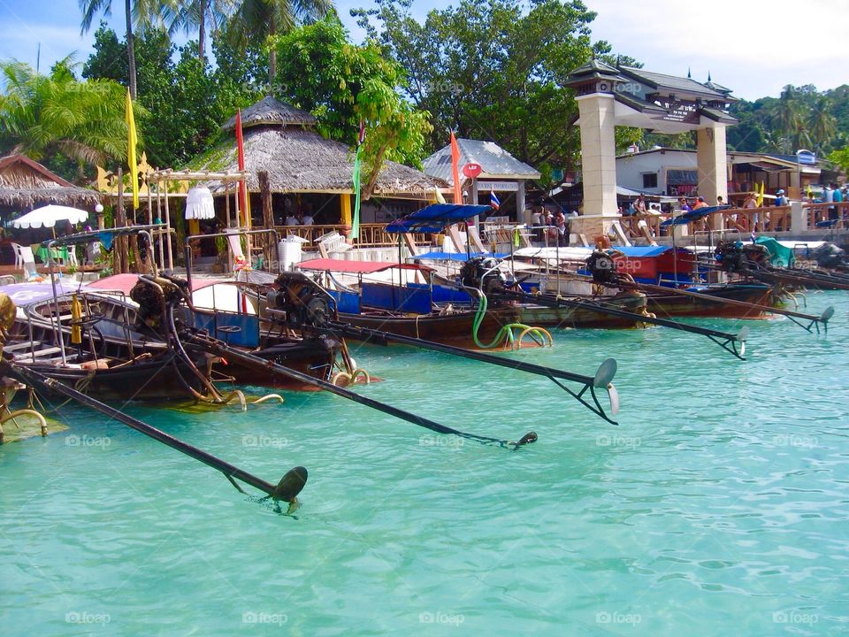 Boats on a row on a beach in Thailand