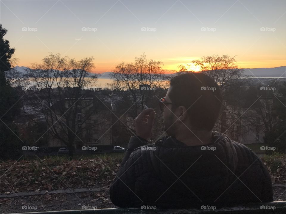 Rear view of man sitting on bench