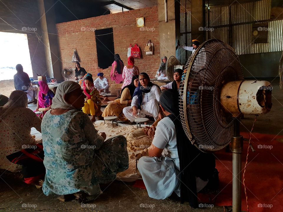 A group of volunteers preparing food for devotees at amritsar,punjab