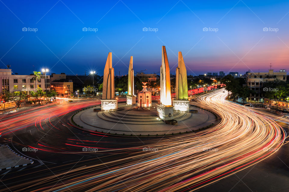 Democracy Monument with lights of the traffic at night in Bangkok Thailand 
