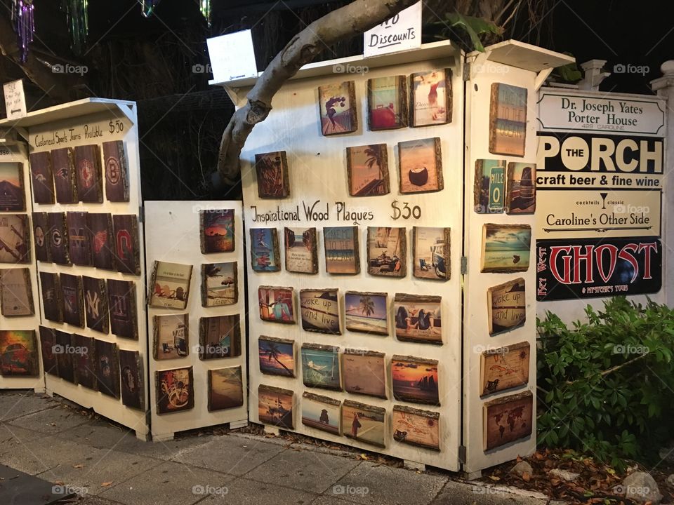 Key west downtown. Strolling by creative inspirational wood plaques. 