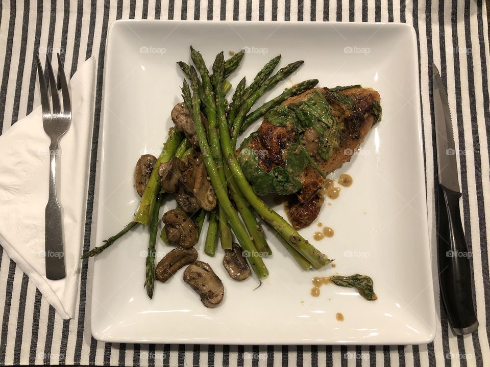 Plated Tuscan Chicken with Asparagus and Mushrooms 