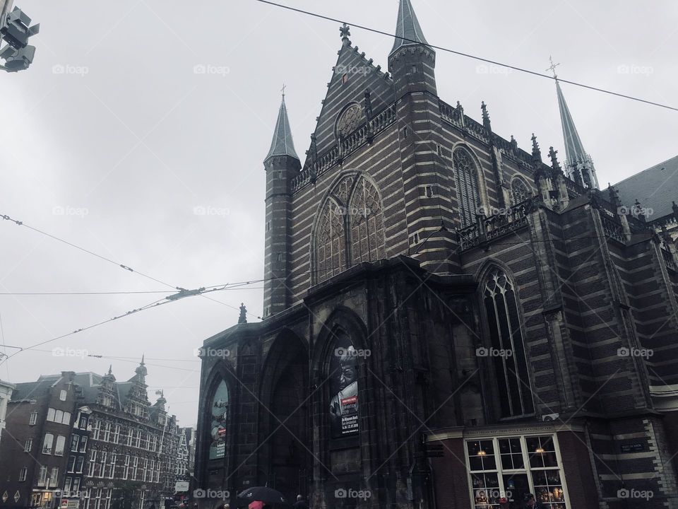 A church in downtown Amsterdam on a rainy day. 