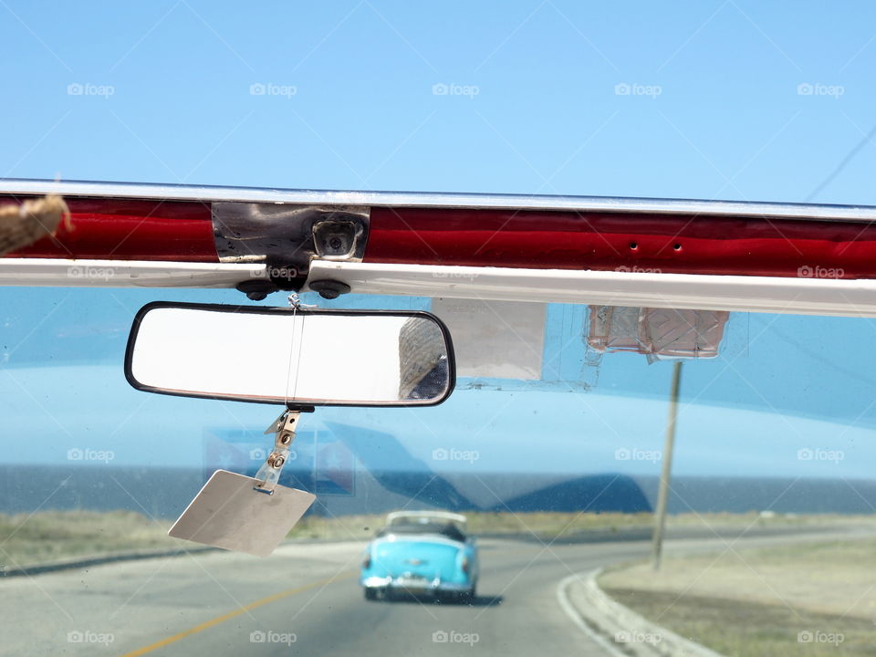 Driving in a red topless oldtimer through Havana, Cuba.