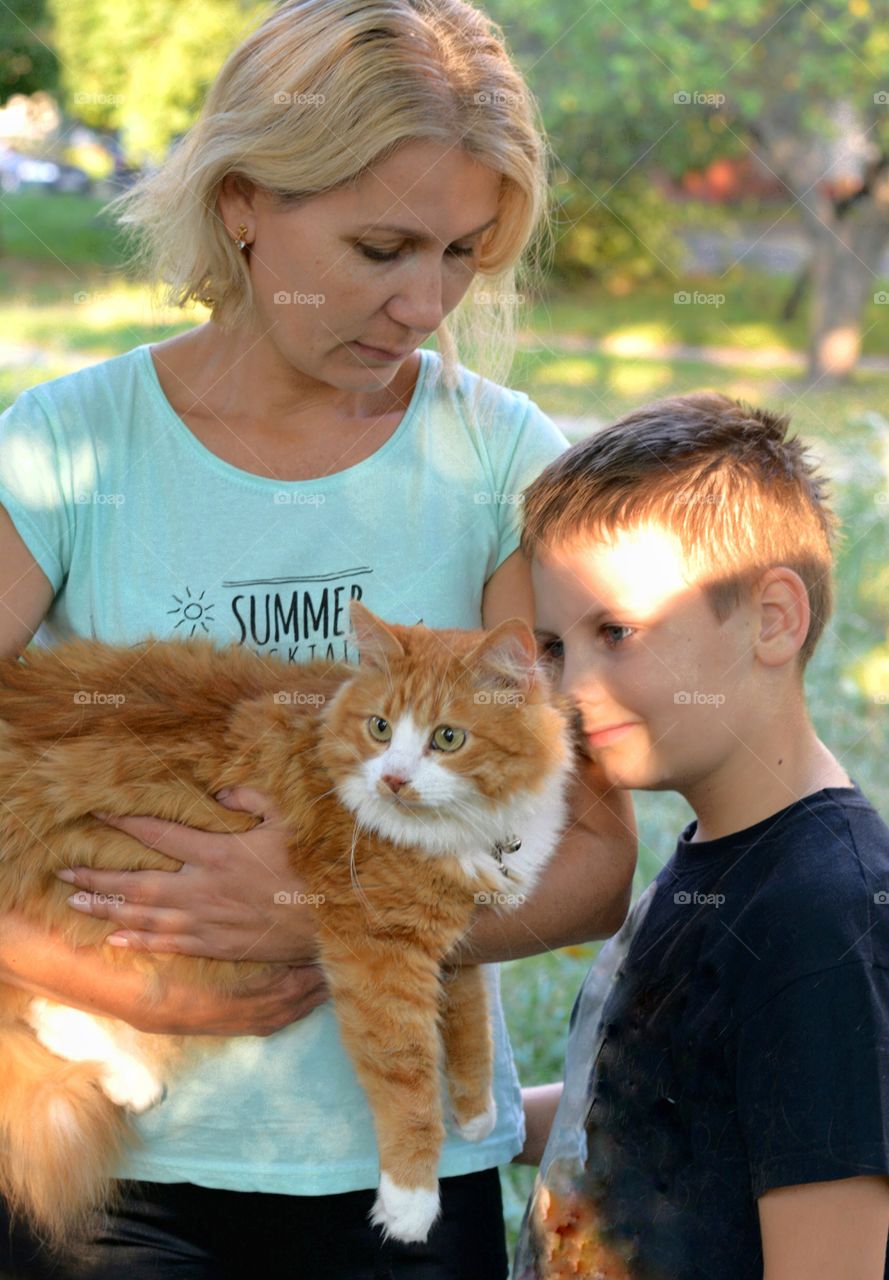 woman and child with ginger cat outdoor family