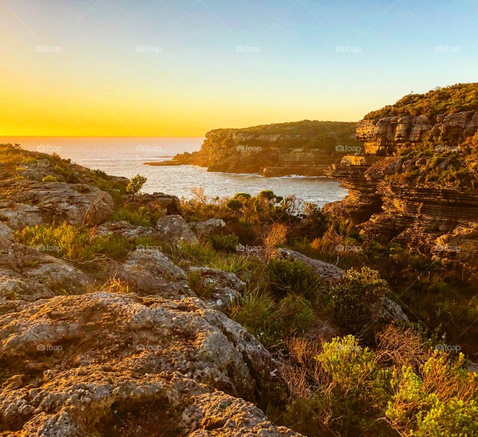 Sunrise at the rocky cliffs overlooking the sea