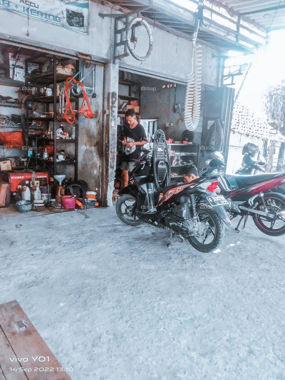 Prince Cinta's busy motorcycle repair shop