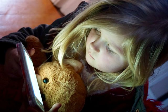 Cute little girl using smartphone