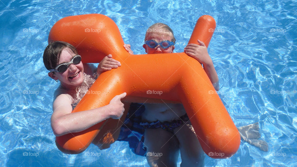 Children having fun in a pool